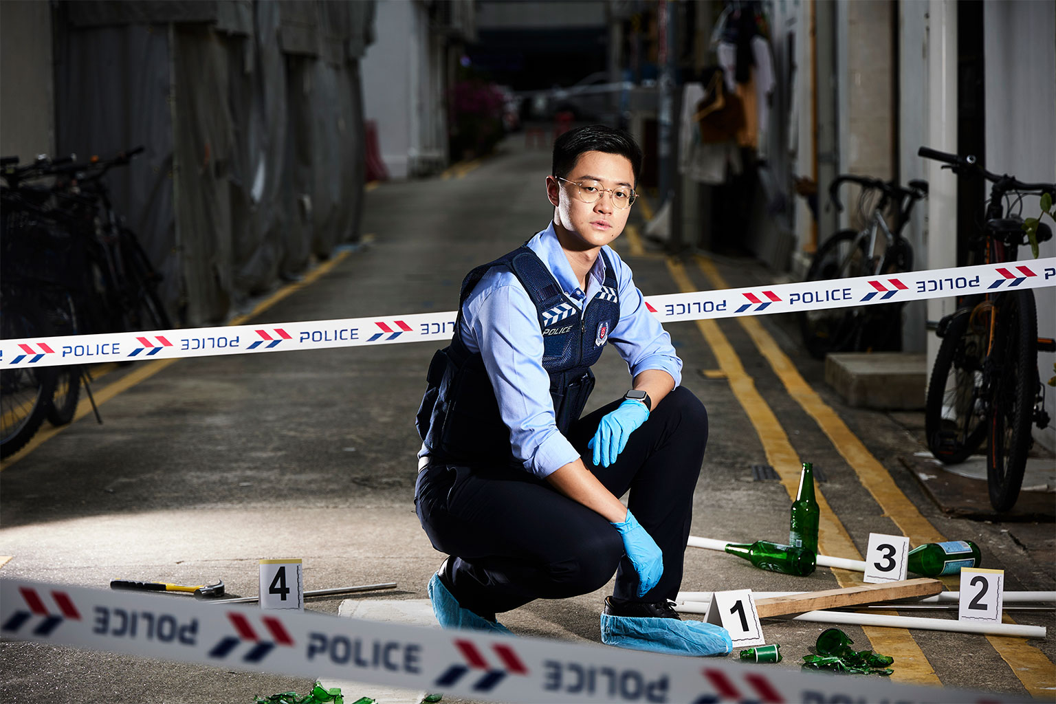 ASP Alden Tan from the Tanglin police force division at an alleyway crime scene